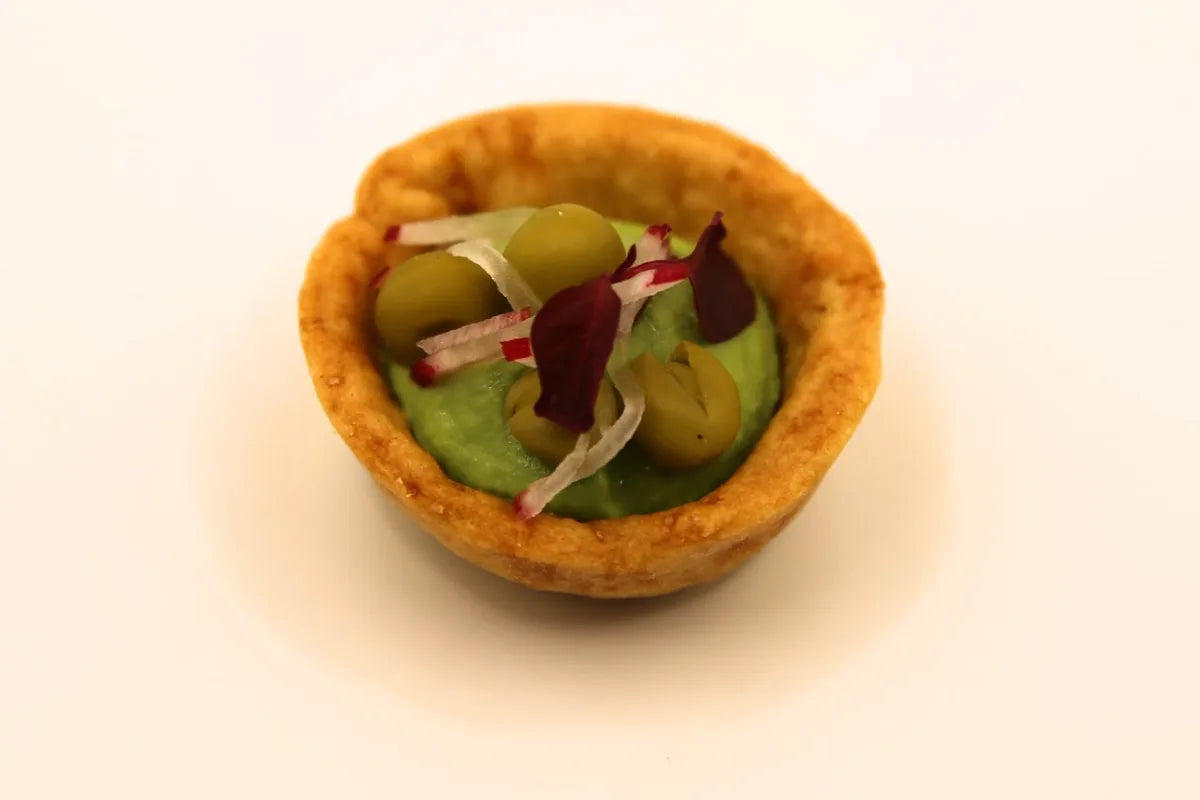 Crisp pastry tartlet filled with green pea purée, peas, shaved radish and red amaranth
