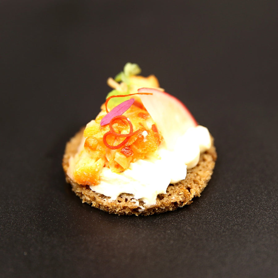 Smoked trout canapé on dark rye with horseradish cream, pickled radish and chilli